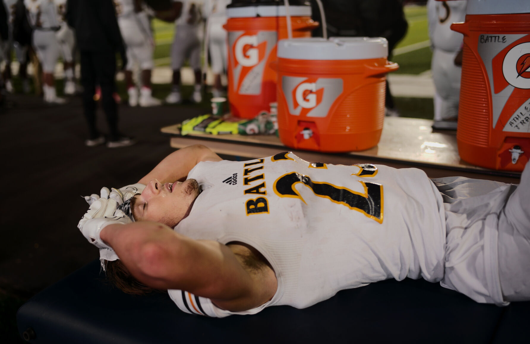 Battle senior Tommy Atherton rests after getting the wind knocked out of him